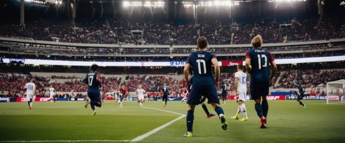 A group of soccer players in blue uniforms on a green field, with a crowd of spectators in the background.