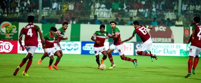 A_group_of_soccer_players_in_red_and_green_uniforms_on_a_field A group of soccer players in red and green uniforms on a field.