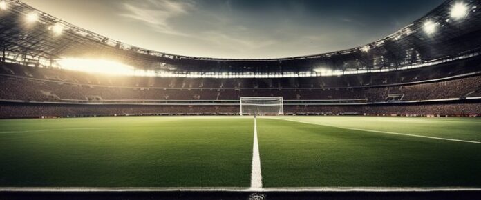 A large, empty soccer stadium with a green field and goalposts.