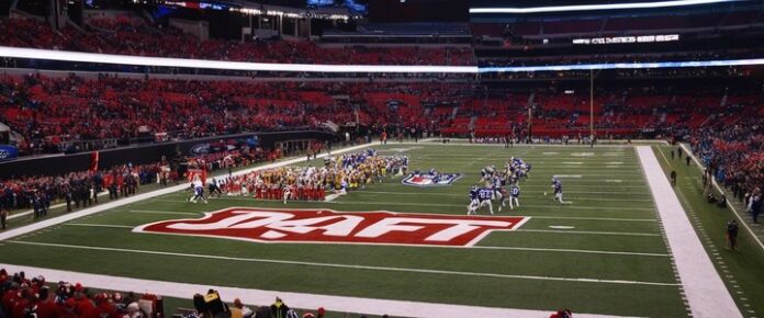 Payton sitting at a poker table, looking at cards.