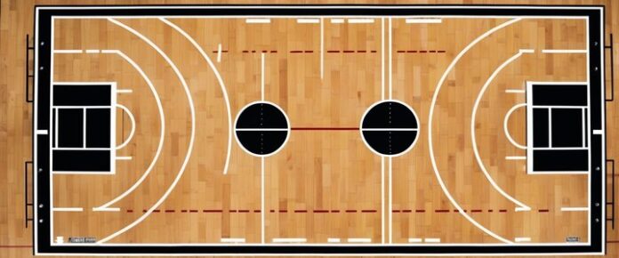 Poker player holding cards at a tournament table.