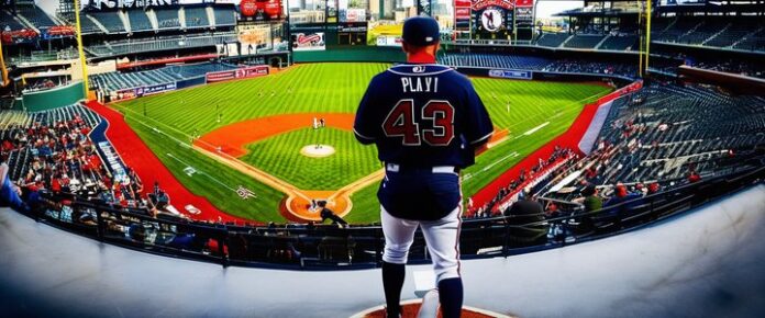 Two baseball players in dark blue uniforms stand on a baseball field, facing away from the camera.