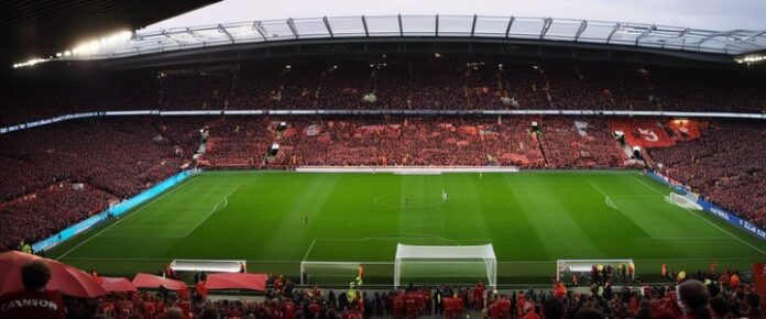 Arne Slot at a poker table, focusing on his cards intensely.