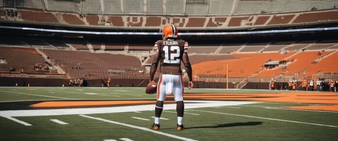 Browns' Sanders holding jersey with number 12, smiling.