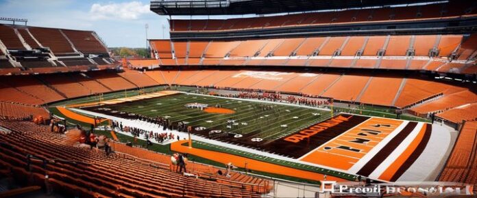 Charles Woodson posing with Browns jersey, reportedly buying team stake.