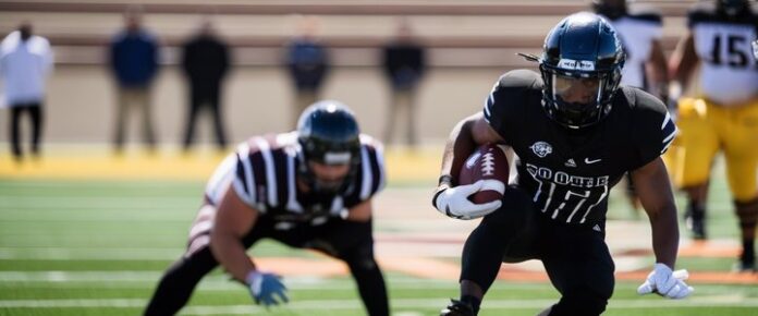 Deion Sanders reacts to recruiting update during press conference.