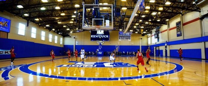 Kentucky and Louisville basketball teams facing off on the court.