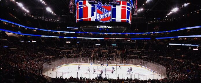 New York Rangers players on the ice during a hockey game