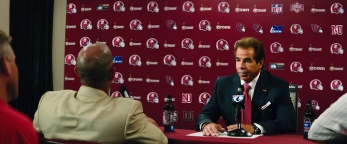 Nick Saban speaking at a press conference, microphone in hand.
