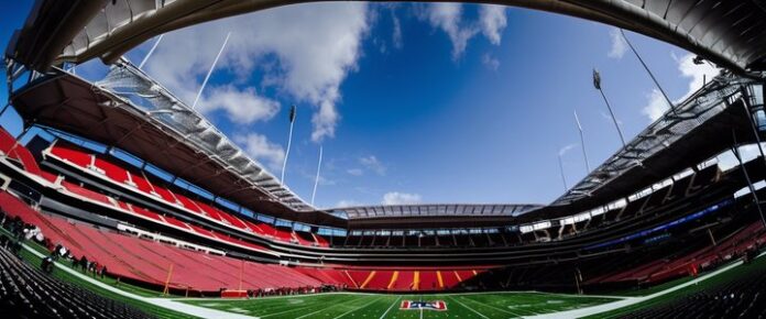 Poker players competing at a tournament table with cards and chips.