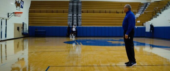Sean Miller shakes hands after contract approval ceremony.
