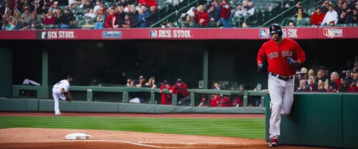Triston Casas sitting with knee wrapped in bandage, looking disappointed.